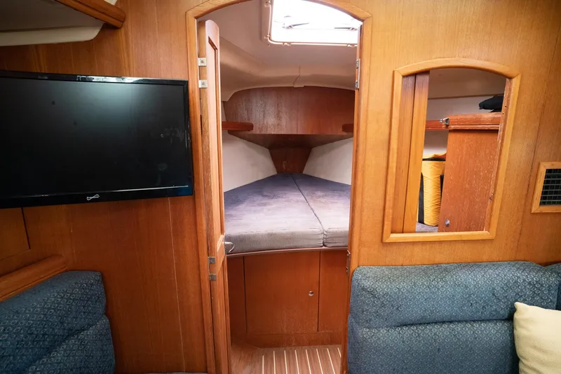 Slide: The Image of Interior of 2004 Hunter 36 sailboat with cozy cabin and mounted TV. - 20