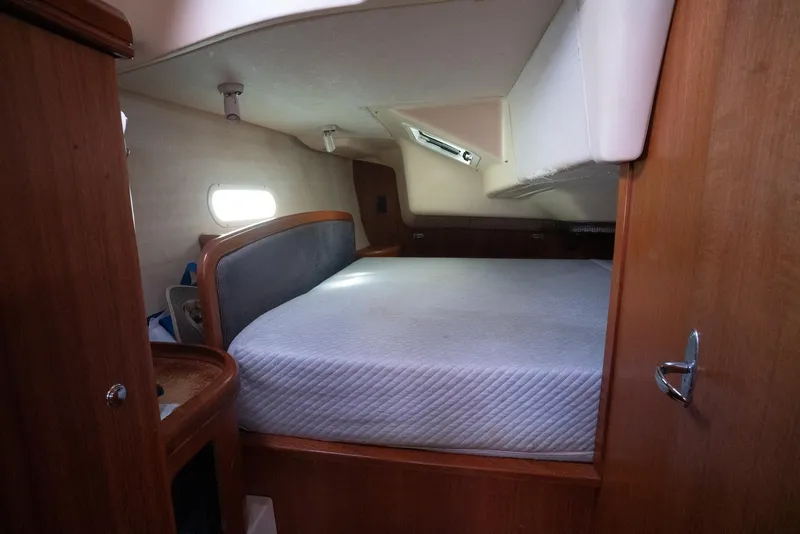 Slide: The Image of Cozy cabin interior of a 2004 Hunter 36 sailboat with a comfortable bed. - 21