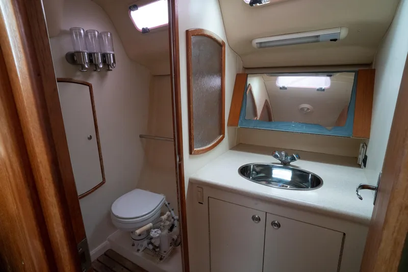 Slide: The Image of 2004 Hunter 36 yacht bathroom with sink, toilet, and mirror. - 23