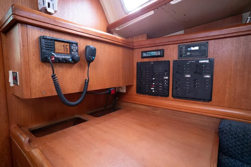 Slide: The Image of 2004 Hunter 36 yacht interior with navigation equipment and control panels. - 24