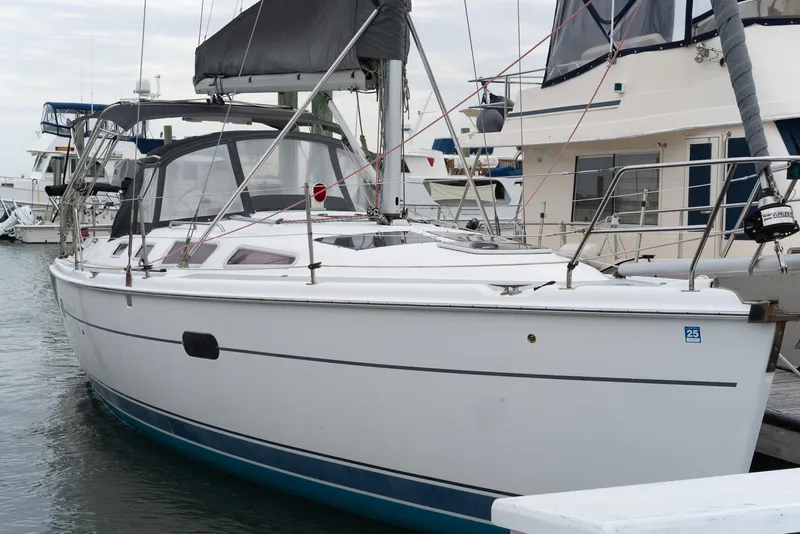 Slide: The Image of 2004 Hunter 36 sailboat docked at marina, featuring sleek white hull and modern design. - 3