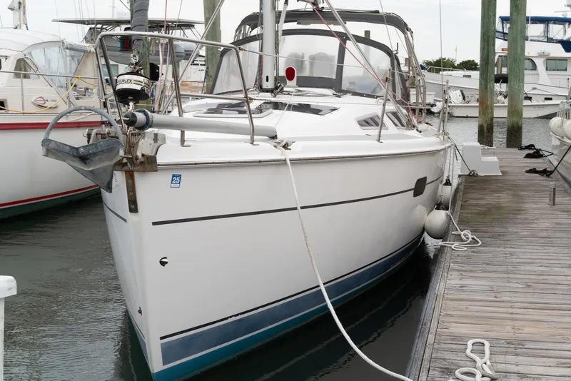 Slide: The Image of 2004 Hunter 36 sailboat docked at a marina, featuring sleek design and modern amenities. - 4