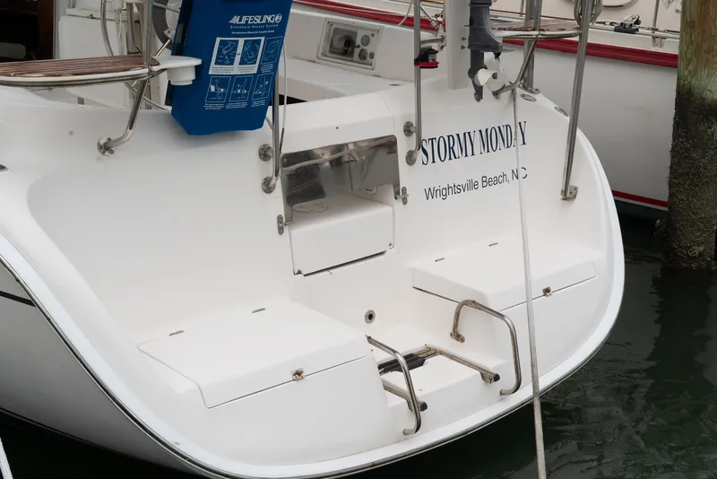 Slide: The Image of Hunter 36 sailboat stern, named "Stormy Monday," docked at Wrightsville Beach, NC. - 6