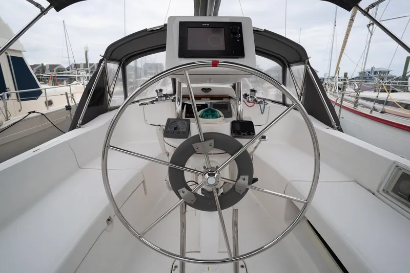 Slide: The Image of Cockpit of 2004 Hunter 36 sailboat with steering wheel and navigation equipment. - 7