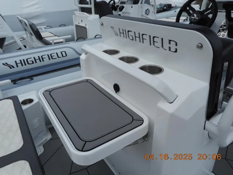 Slide: The Image of 2025 Highfield Sport 560 boat interior with seating and cup holders. - 11