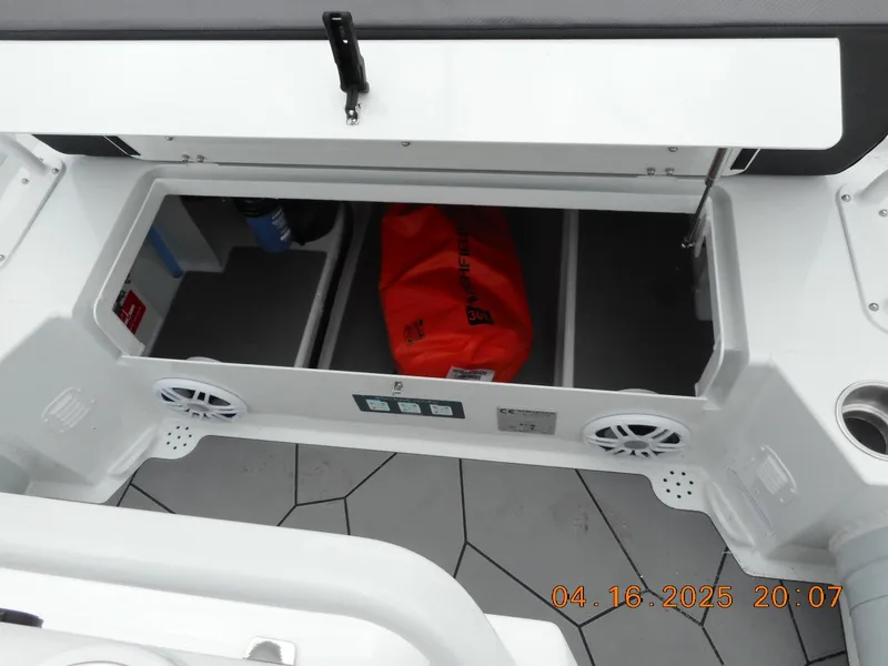 Slide: The Image of 2025 Highfield Sport 560 boat storage compartment with speakers and equipment. - 12