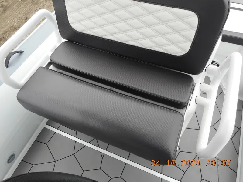 Slide: The Image of 2025 Highfield Sport 560 boat seat with black and white upholstery, geometric flooring. - 14