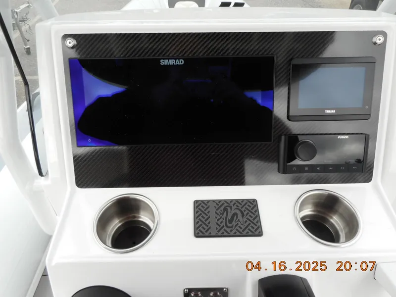 Slide: The Image of Control panel of 2025 Highfield Sport 560 boat with Simrad display and cup holders. - 15