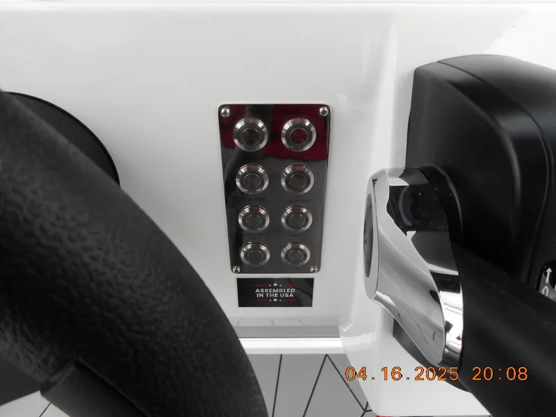 Slide: The Image of Control panel of 2025 Highfield Sport 560 boat with steering wheel and throttle. - 17