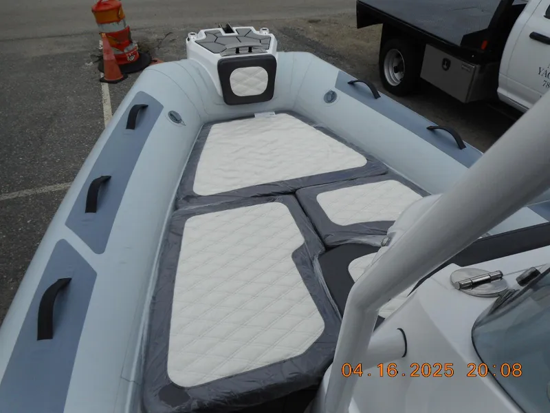 Slide: The Image of 2025 Highfield Sport 560 boat interior with cushioned seating and modern design. - 18
