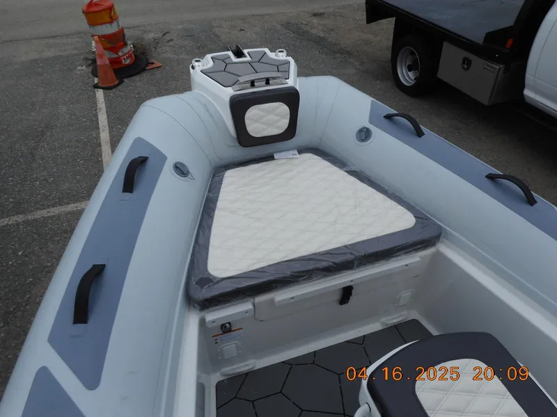 Slide: The Image of 2025 Highfield Sport 560 boat interior with cushioned seating and modern design. - 20