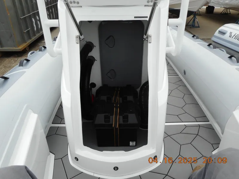 Slide: The Image of 2025 Highfield Sport 560 boat interior with storage compartment and hexagonal flooring. - 21