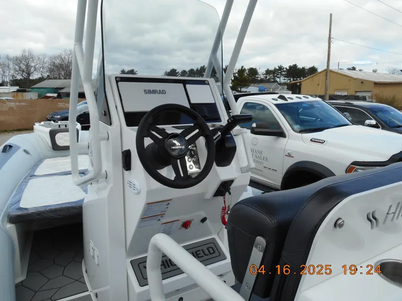 Slide: The Image of 2025 Highfield Sport 560 boat dashboard with steering wheel and controls. - 6