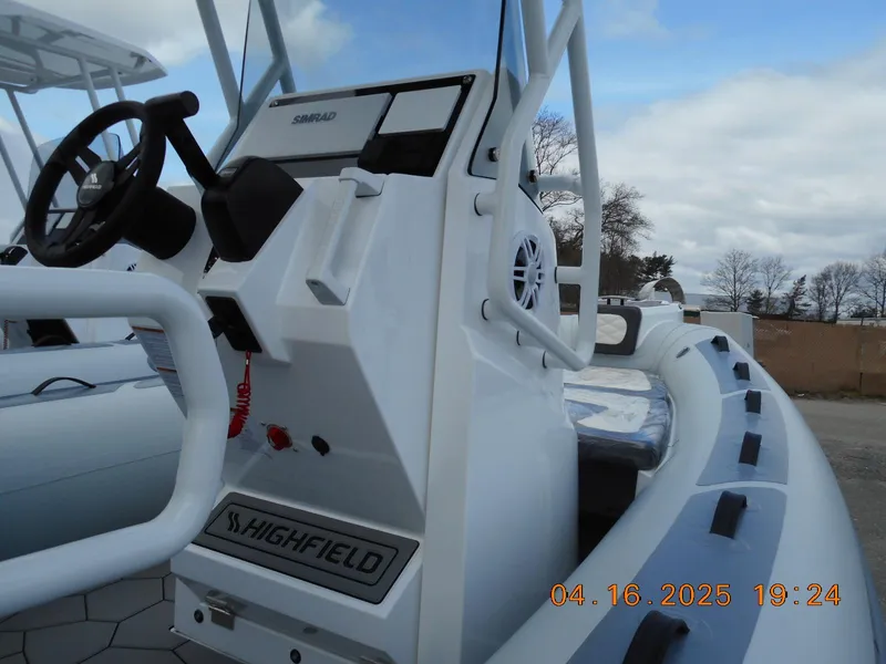 Slide: The Image of 2025 Highfield Sport 560 boat console with steering wheel and controls. - 9