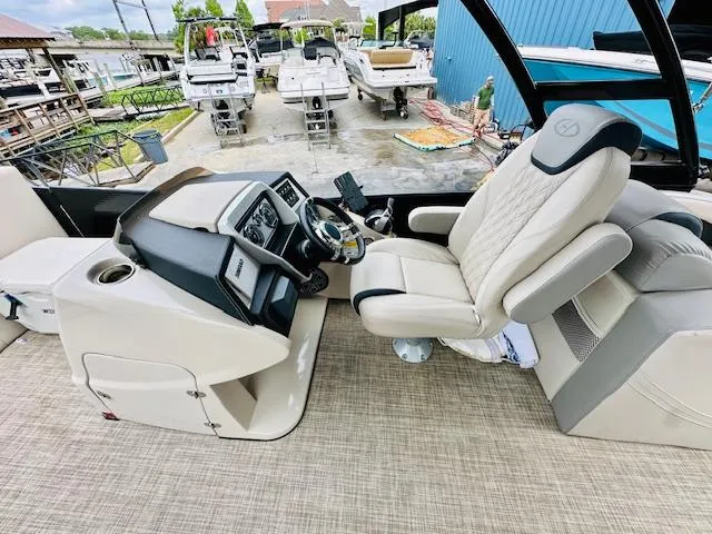 Slide: The Image of 2019 Harris 270 Grand Mariner boat interior with captain's chair and control panel. - 10