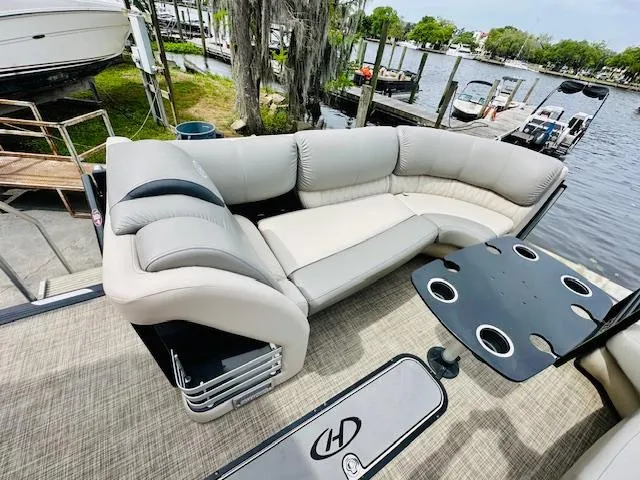 Slide: The Image of 2019 Harris 270 Grand Mariner pontoon boat with plush seating and cupholder table by the dock. - 15