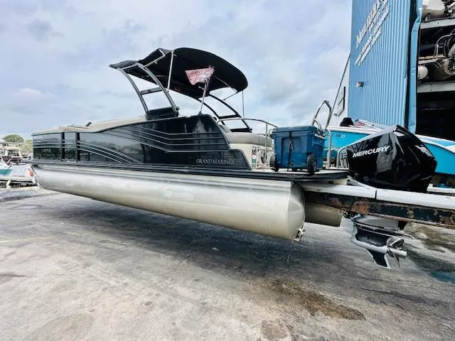 Slide: The Image of 2019 Harris 270 Grand Mariner pontoon boat with Mercury engine, docked outdoors. - 4