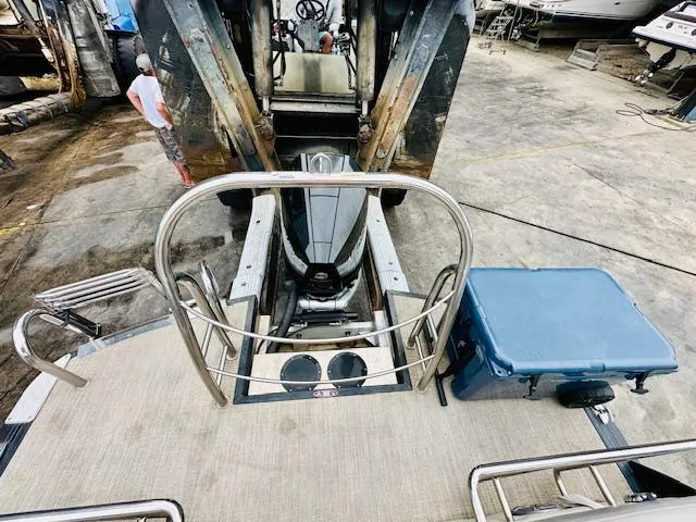 Slide: The Image of 2019 Harris 270 Grand Mariner boat with metal railing and blue cooler on deck. - 8