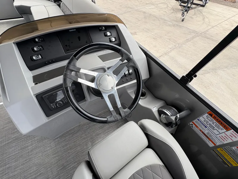 Slide: The Image of Steering console of 2021 Bennington 25 LFBC boat with modern controls and comfortable seating. - 3