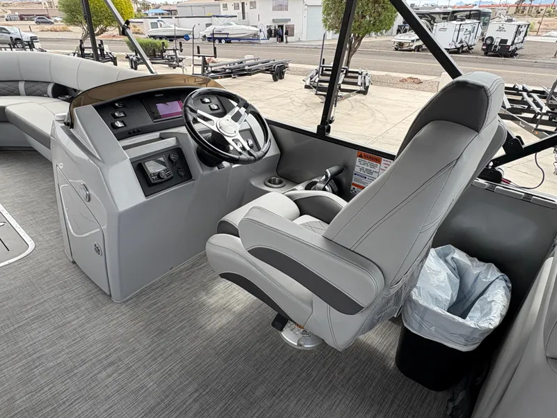 Slide: The Image of 2021 Bennington 25 LFBC boat interior with captain's chair and control panel. - 4