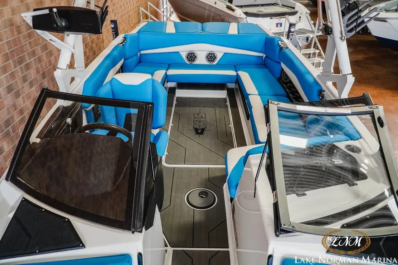 Slide: The Image of 2019 Axis A24 boat interior with blue seating, modern design, and spacious layout at Lake Norman Marina. - 18