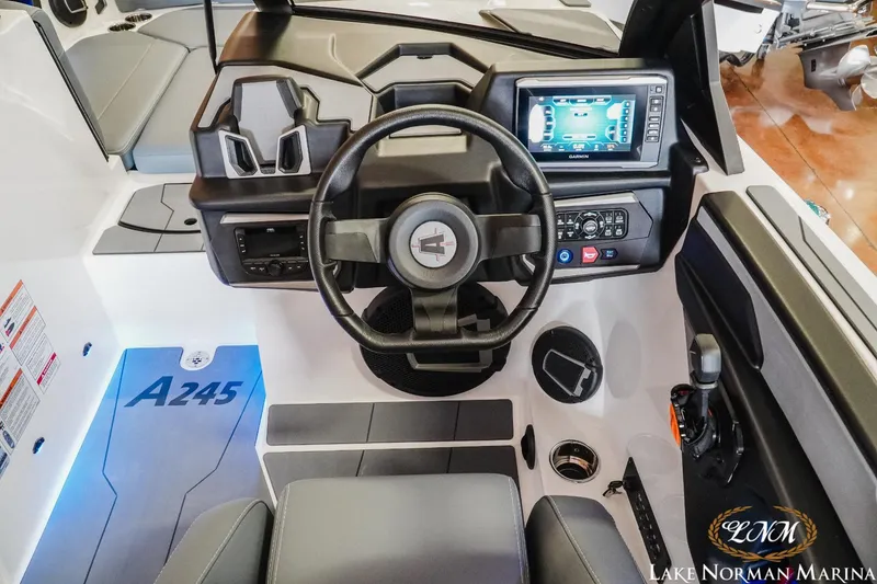 Slide: The Image of 2024 Axis A245 boat dashboard with steering wheel and digital display at Lake Norman Marina. - 11