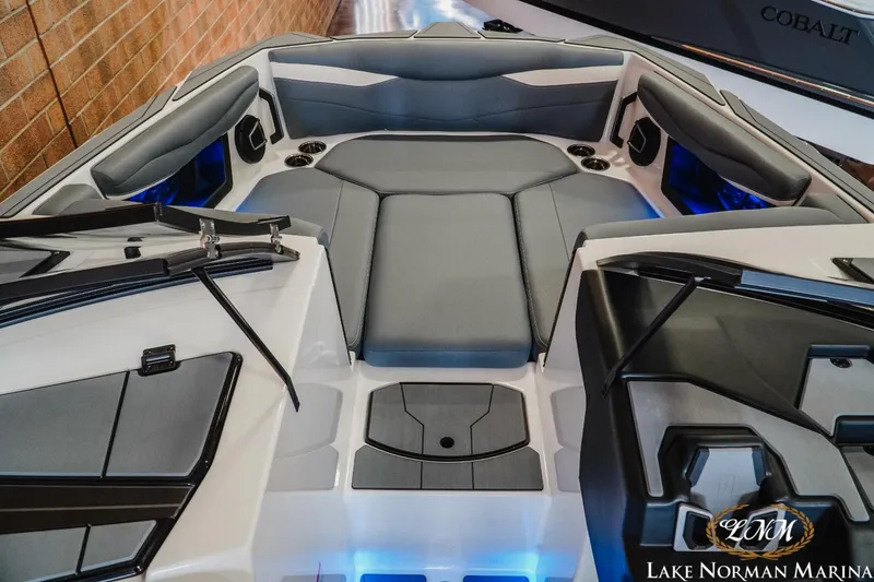 Slide: The Image of 2024 Axis A245 boat interior with gray seating and blue accent lighting at Lake Norman Marina. - 12