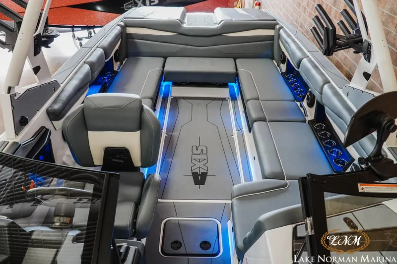 Slide: The Image of 2024 Axis A245 boat interior with gray seating and blue LED lighting. - 14