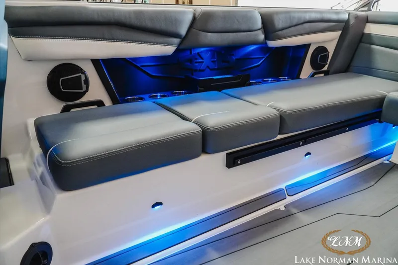 Slide: The Image of 2024 Axis A245 boat interior with blue LED lighting and cushioned seating at Lake Norman Marina. - 16