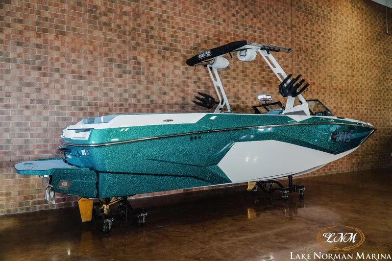 Slide: The Image of 2024 Axis A245 boat displayed indoors at Lake Norman Marina. - 2