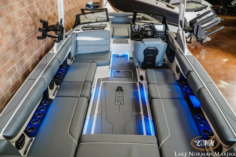 Slide: The Image of 2024 Axis A245 boat interior with gray seating and blue LED lighting at Lake Norman Marina. - 8