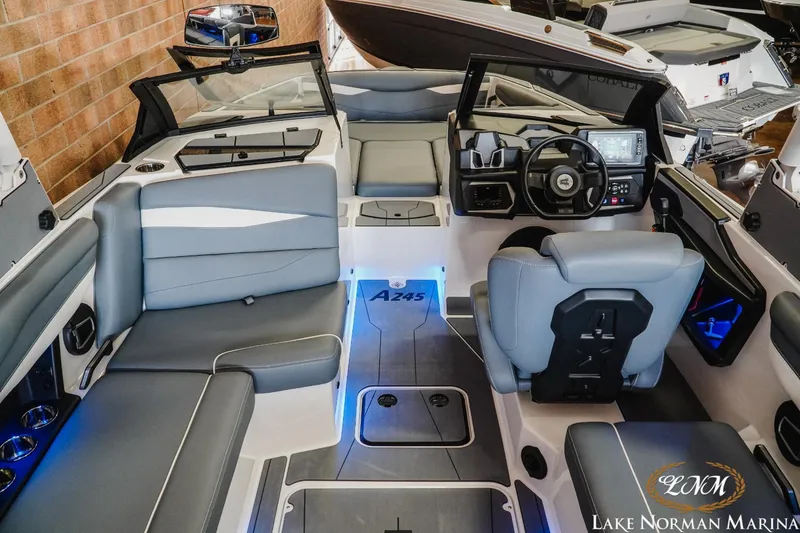 Slide: The Image of 2024 Axis A245 boat interior with modern seating and advanced dashboard at Lake Norman Marina. - 9