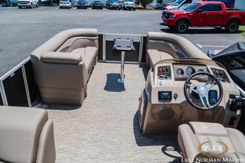 Slide: The Image of 2024 Bennington 20SSR pontoon boat interior with seating and steering console at Lake Norman Marina. - 5