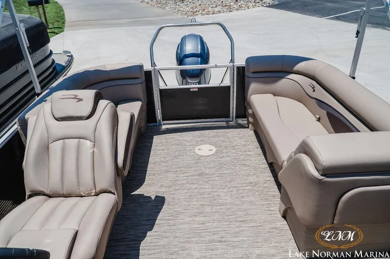 Slide: The Image of 2024 Bennington 20SSR pontoon boat interior with plush seating at Lake Norman Marina. - 9