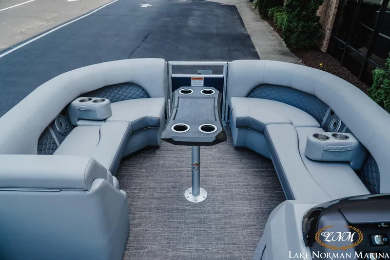 Slide: The Image of 2025 Bennington 22LSB pontoon boat interior with plush seating and cup holders at Lake Norman Marina. - 10