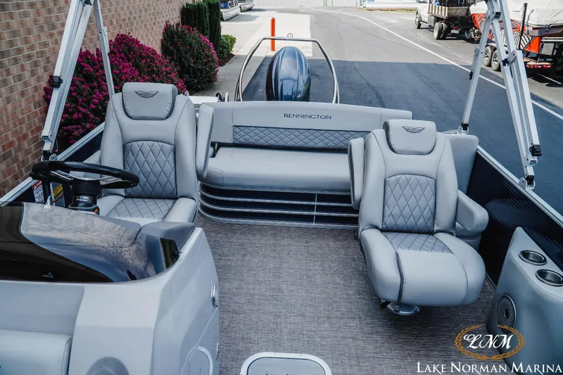 Slide: The Image of 2025 Bennington 22LSB pontoon boat interior with plush seating at Lake Norman Marina. - 14
