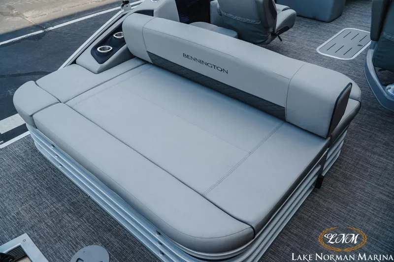 Slide: The Image of 2025 Bennington 22LSB boat interior with gray seating and cup holders at Lake Norman Marina. - 6