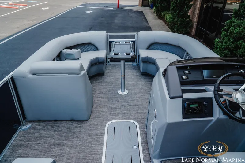 Slide: The Image of 2025 Bennington 22LSB pontoon boat interior with plush seating and modern helm. - 7