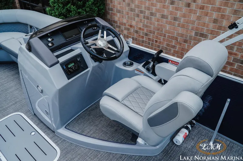 Slide: The Image of 2025 Bennington 22LSB boat helm with modern steering and controls at Lake Norman Marina. - 8