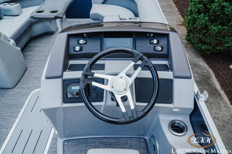 Slide: The Image of 2025 Bennington 22LSB boat dashboard with steering wheel and control panel. - 9