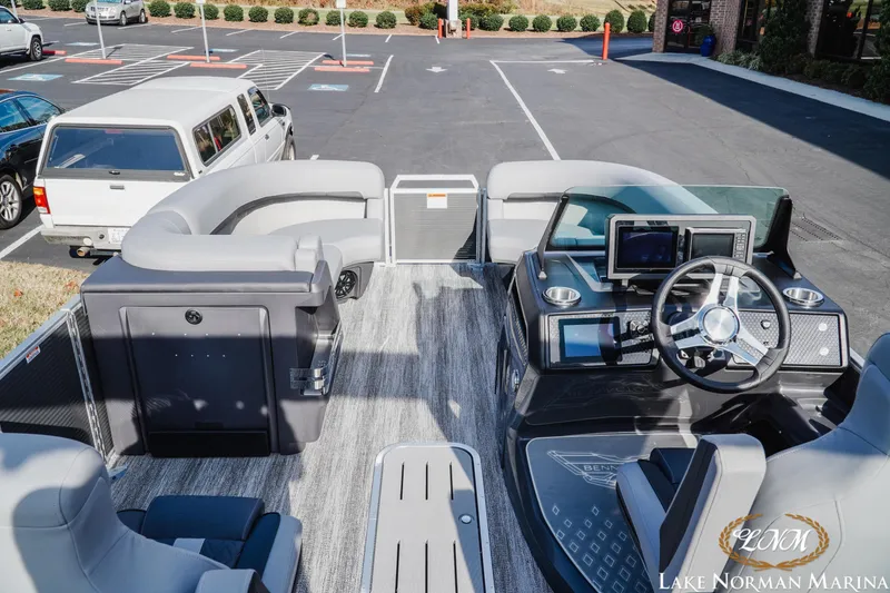 Slide: The Image of 2025 Bennington 22MFB pontoon boat interior with modern dashboard and seating at Lake Norman Marina. - 10