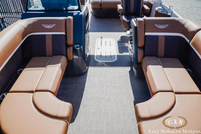 Slide: The Image of 2025 Bennington 22MSB boat interior with luxurious brown seating at Lake Norman Marina. - 10