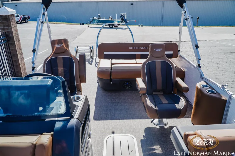 Slide: The Image of 2025 Bennington 22MSB pontoon boat interior with brown seating at Lake Norman Marina. - 11