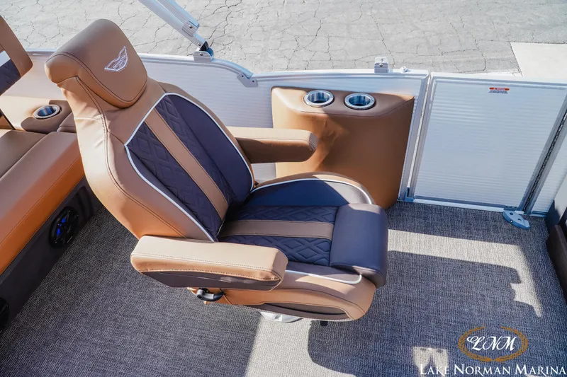 Slide: The Image of Luxurious seating on 2025 Bennington 22MSB boat with cup holders, brown and black upholstery. - 13