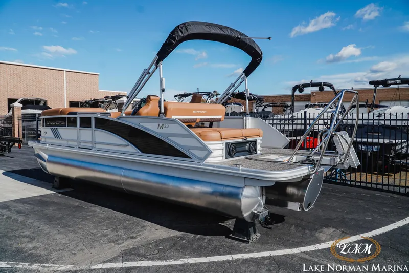 Slide: The Image of 2025 Bennington 22MSB pontoon boat at Lake Norman Marina, featuring sleek design and comfortable seating. - 3