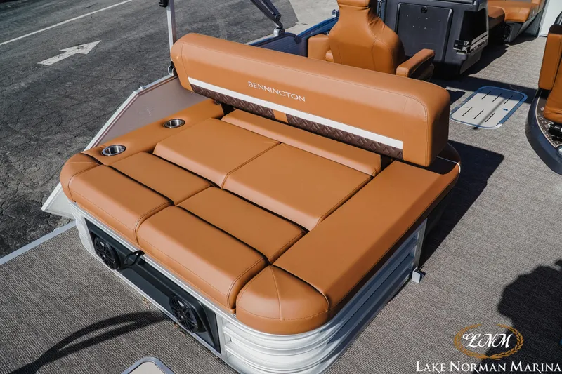 Slide: The Image of 2025 Bennington 22MSB boat with luxurious tan seating and cup holders at Lake Norman Marina. - 4