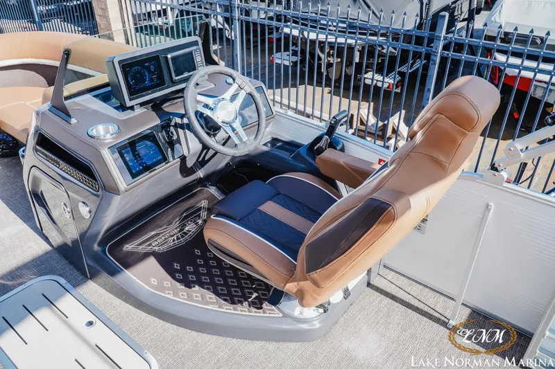 Slide: The Image of 2025 Bennington 22MSB boat helm with modern controls and comfortable seating at Lake Norman Marina. - 6