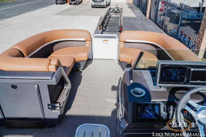 Slide: The Image of 2025 Bennington 22MSB pontoon boat interior with tan seating and modern dashboard. - 8