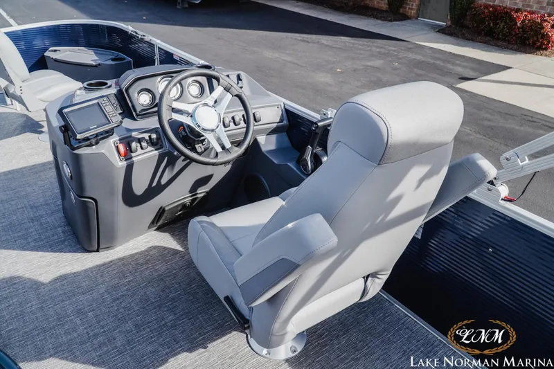 Slide: The Image of 2024 Bennington 22SF-SPS boat cockpit with steering wheel and control panel at Lake Norman Marina. - 10