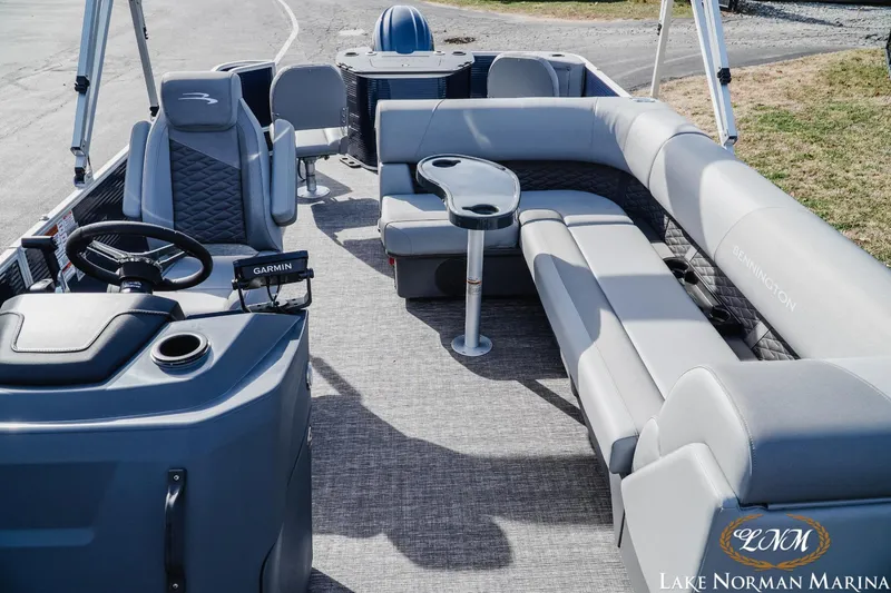 Slide: The Image of 2024 Bennington 22SF-SPS pontoon boat interior with plush seating and modern helm. - 13